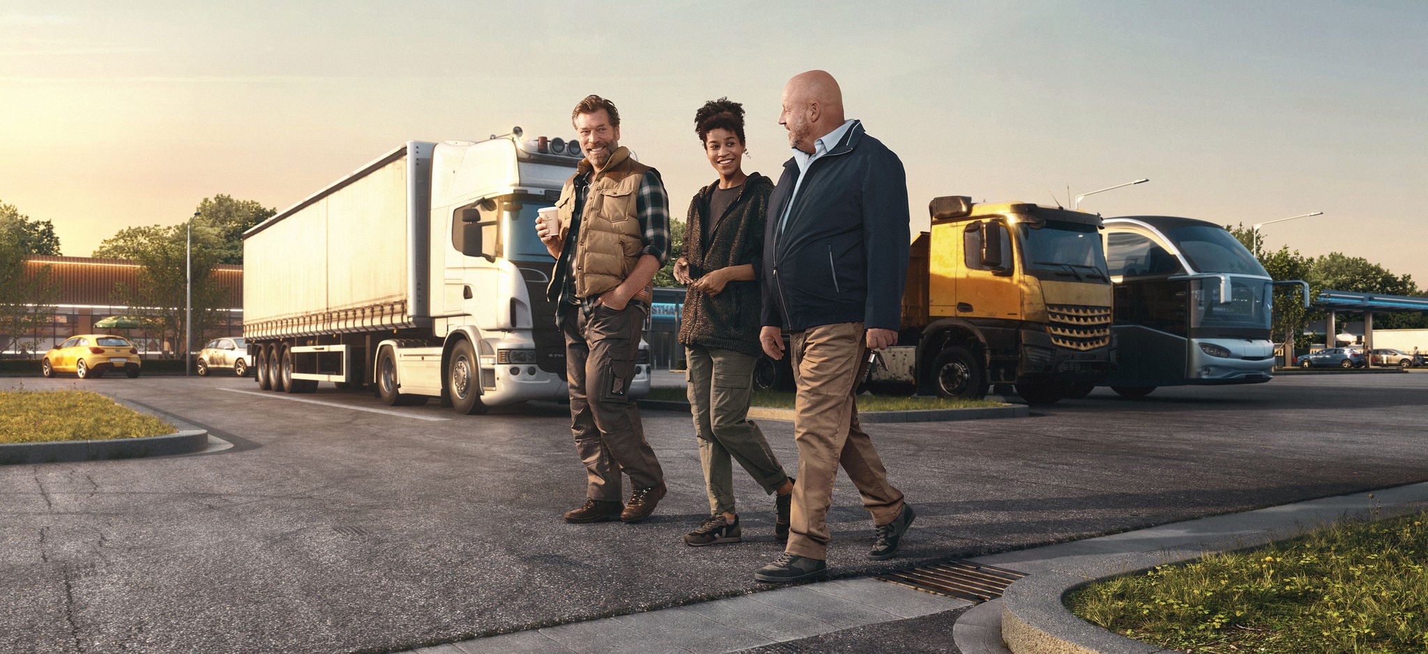 three people walking infront of trucks