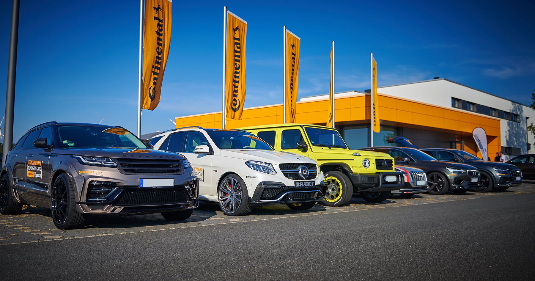 Cars parking on a car dealers ground.