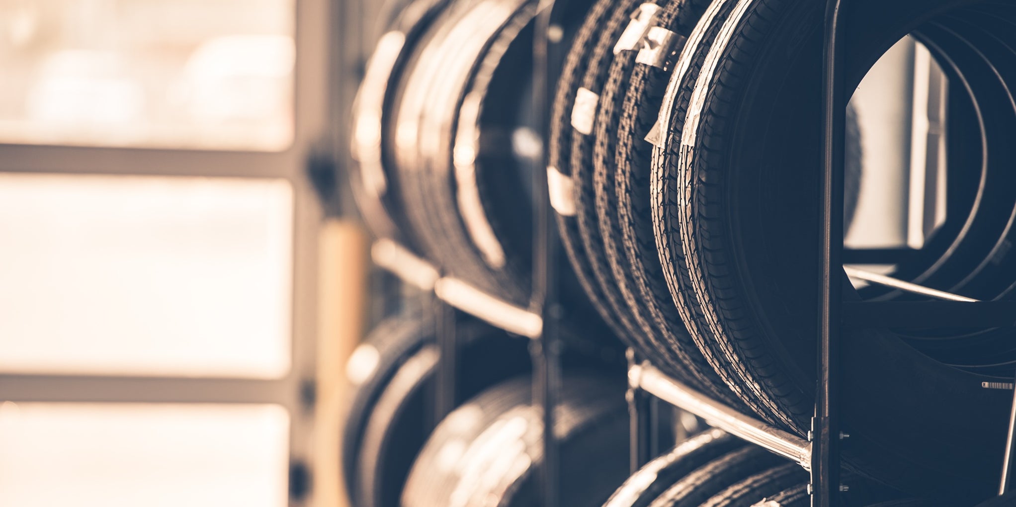 Car Tires Rack. Brand New Tires for Compact Vehicles on the Metal Display.