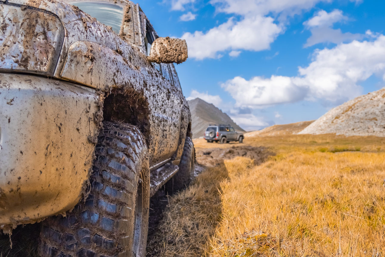 Adventure travel concept background. 4x4 off-road suv car stuck in mud. Adventure travel concept background. Offroad car.