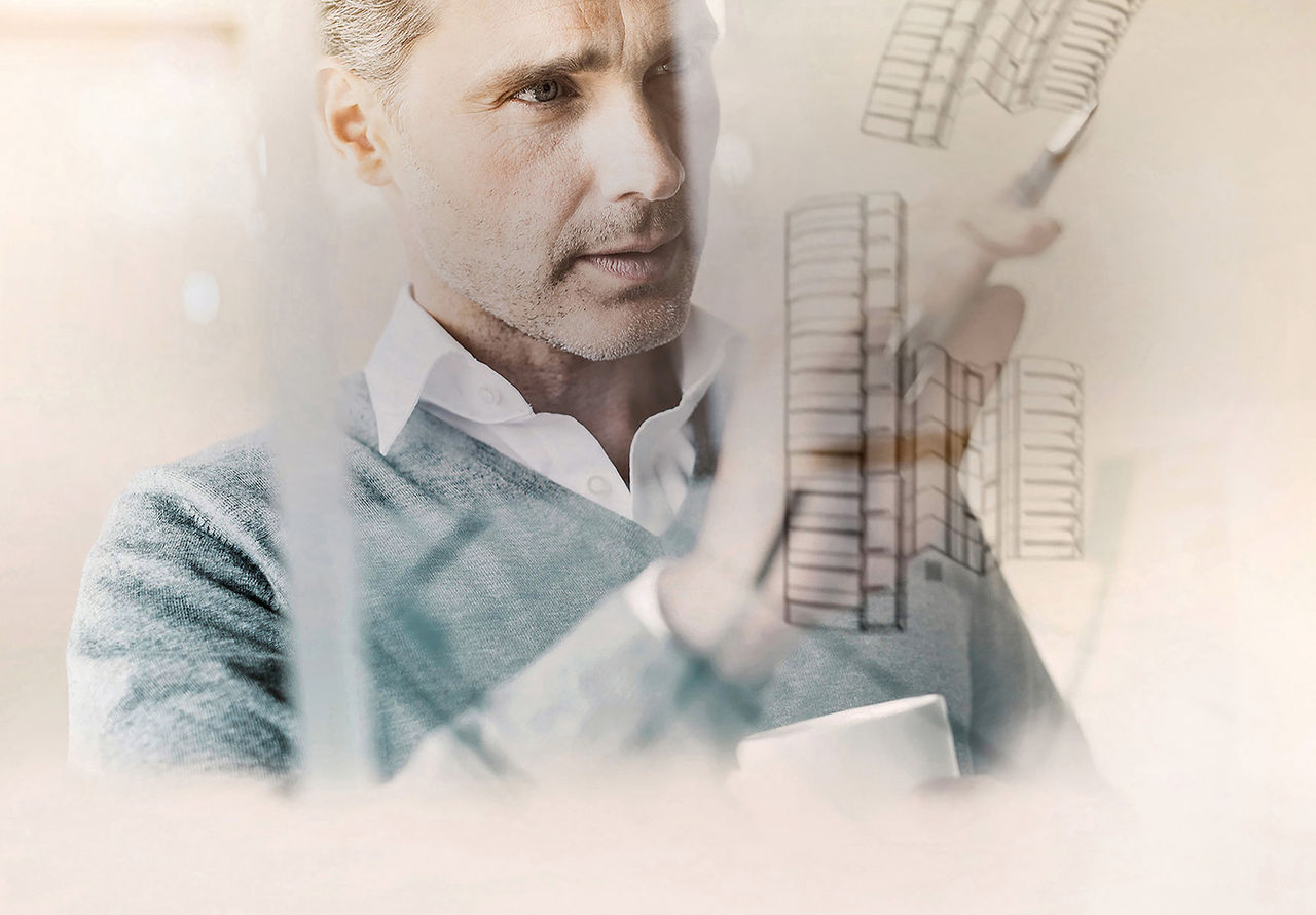 Technical illustrator drawing on a glass board