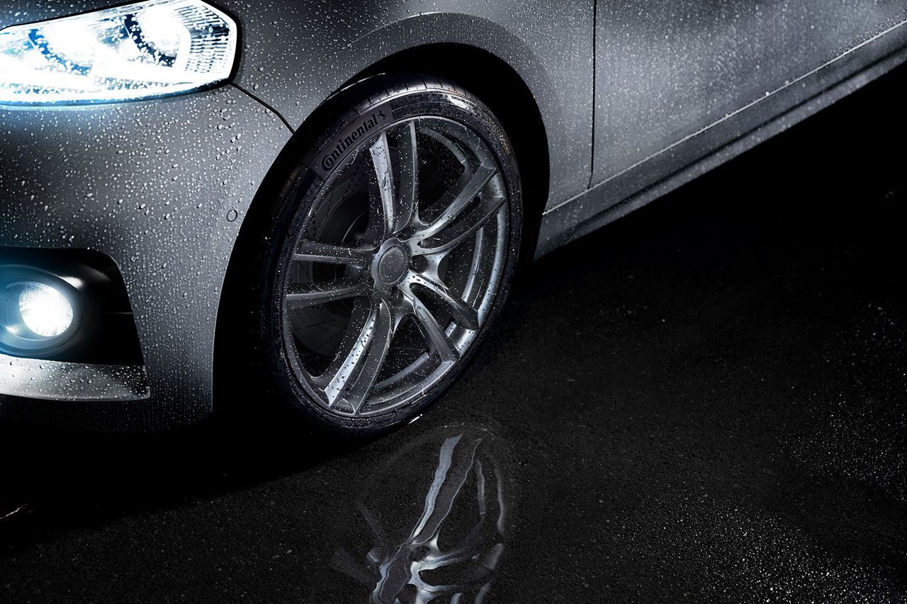Continental Tire shown in a puddle while it is raining.